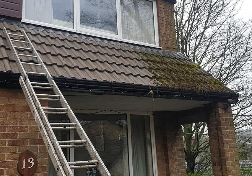 photo of a roof cleaning company in holmfirth applying a bio-wash to a roof